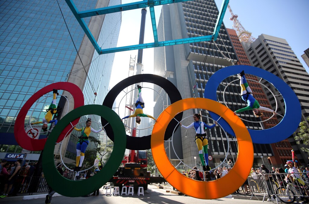 Acrobats perform on the Olympics rings at Paulista Avenue in Sao Paulo's financial center, Brazil, July 24, 2016.