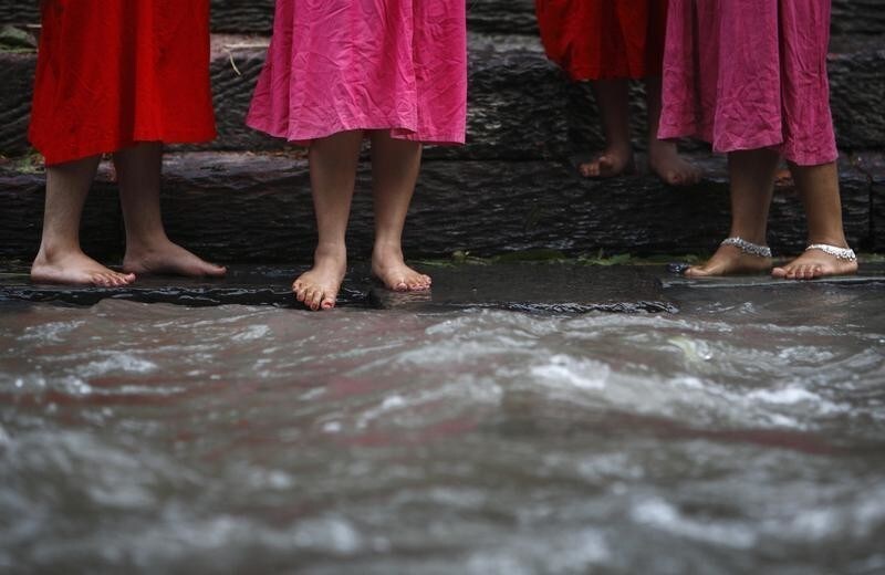 Feet of Nepalese woman are pictured as they get ready to take a bath in the bank of Bagmati River, during the Rishi Panchami festival, in Kathmandu September 20, 2012. Rishi Panchami is observed on the last day of Teej when women worship Sapta Rishi (Seven Saints) to ask for forgiveness for sins committed during their menstruation periods throughout the year. The Hindu religion considers menstruation as a representation of impurity and women are prohibited from taking part in religious practices during their monthly cycles. REUTERS/Navesh Chitrakar (NEPAL - Tags: SOCIETY RELIGION) - GM1E89K0YQ001