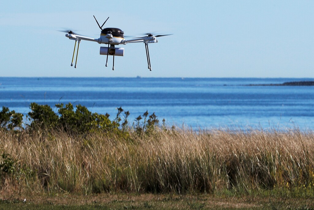 A drone, made by CyPhy Works, delivers a UPS package on Children's Island off the coast of Beverly, Massachusetts, U.S. September 22, 2016, during UPS's demonstration of a drone making a commercial delivery of a package to a remote or difficult-to-access location. Picture taken September 22, 2016. REUTERS/Brian Snyder - S1BEUCYKOTAA
