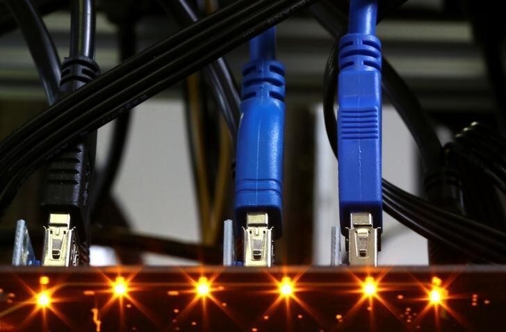 Cables plugged into a Bitcoin mining computer server are pictured in Bitminer Factory in Florence, Italy, April 6, 2018. Picture taken April 6, 2018. REUTERS/Alessandro Bianchi