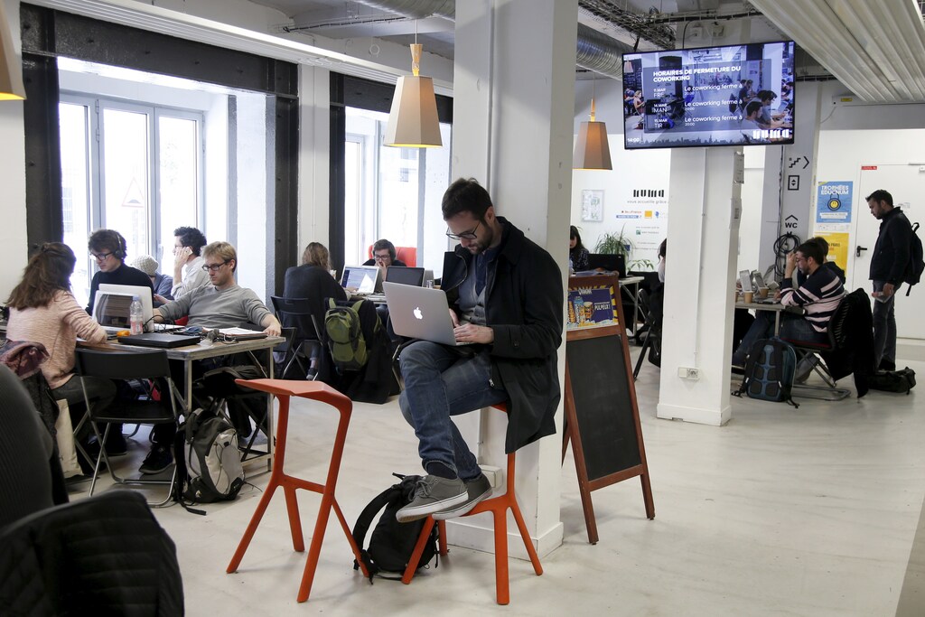 Entrepreneurs work at their computer laptops at the so-called "incubator" of French high-tech start-ups "Numa" in Paris, France, in this March 11, 2016 file photo. REUTERS/Charles Platiau/Files - RTX29XRP