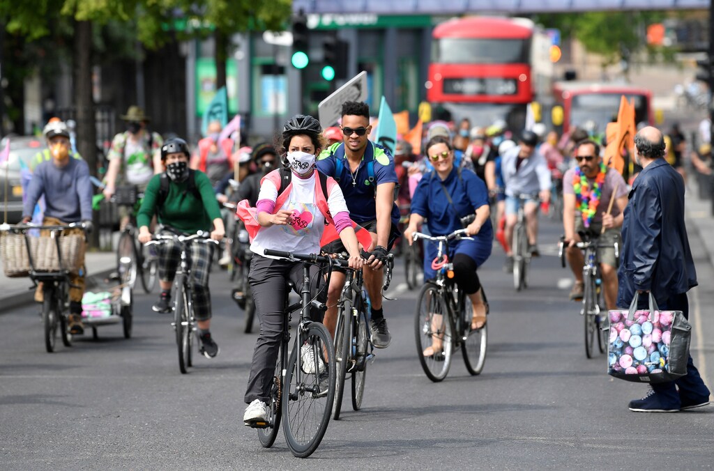 Members of Extinction Rebellion take part in a socially distanced bicycle ride to campaign for more cycling and cycle lanes and fewer vehicles on the roads, following the outbreak of the coronavirus disease (COVID-19), London, Britain, May 17, 2020. REUTERS/Toby Melville - RC2EQG9PJ76S