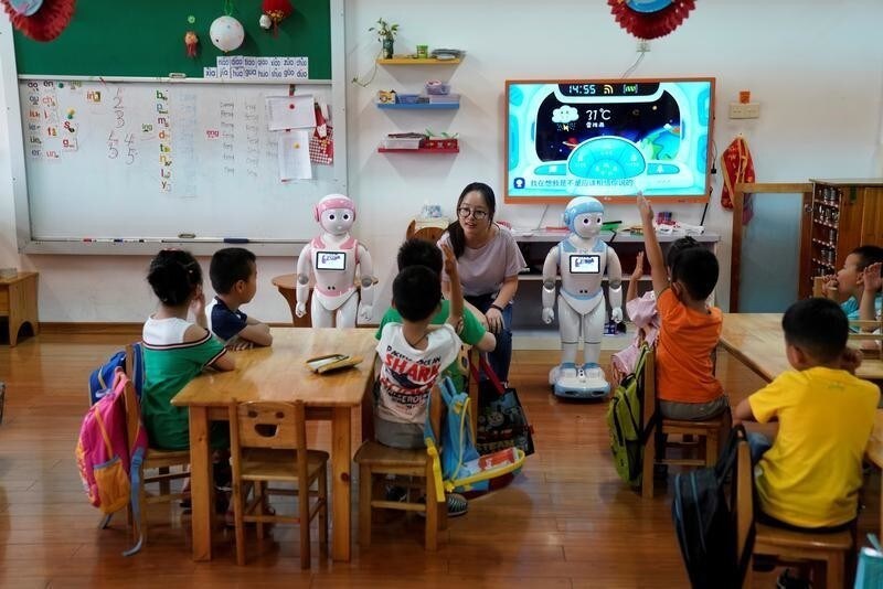 An iPal couple social robot help teach children at a kindergarten in Suzhou, Jiangsu province, China July 4, 2018. Designed to offer education, care and companionship to children and the elderly, the 3.5-feet tall humanoid robots come in two genders and can tell stories, take photos and deliver educational or promotional content. Picture taken July 4, 2018.
