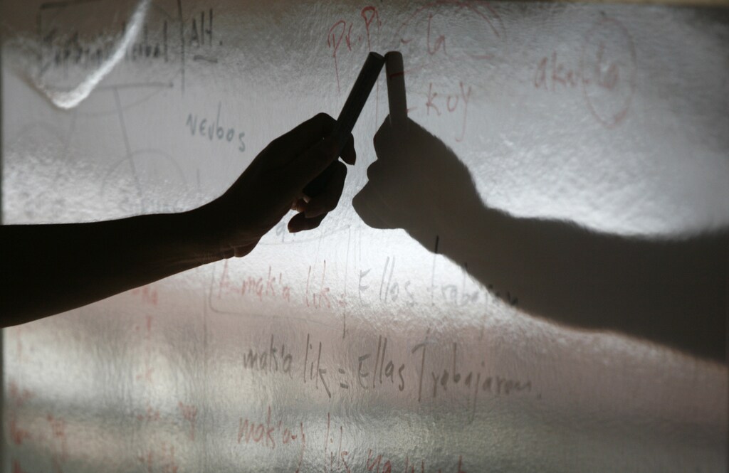 An indigenous teacher explains the grammar of the Xinca language to young community members in Chiquimulilla, Guatemala, February 4, 2007. A bilingual education drive in the mostly Mayan country is reviving 21 languages pushed aside since the Spanish conquest, some of which were close to extinction. Picture taken February 8, 2007. REUTERS/Daniel LeClair (GUATEMALA) - RTR1MDFE