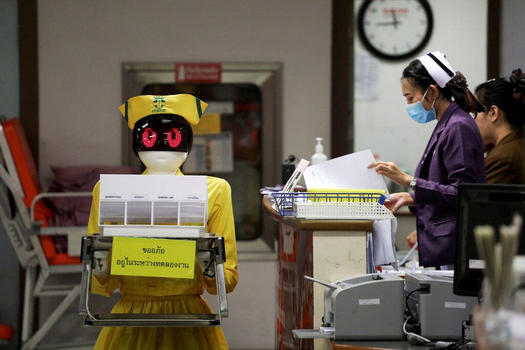 A robot wearing a nurse costume carries medical documents at Mongkutwattana General Hospital in Bangkok, Thailand, February 6, 2019. REUTERS/Athit Perawongmetha TPX IMAGES OF THE DAY - RC16982CDB10