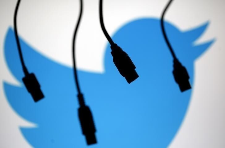 Electronic cables are silhouetted next to the logo of Twitter in this September 23, 2014 illustration photo in Sarajevo. REUTERS/Dado Ruvic (BOSNIA AND HERZEGOVINA - Tags: BUSINESS TELECOMS)