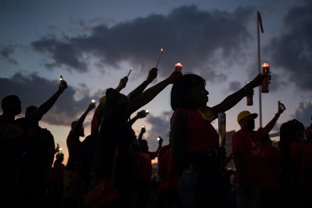 Local residents and alumni of Yates high school take part in a candlelight vigil honoring George Floyd, whose death in Minneapolis police custody has sparked nationwide protests against racial inequality, on the high school field he played football in Houston, Texas, U.S., June 8, 2020. REUTERS/Adrees Latif - RC2E5H9COPP2