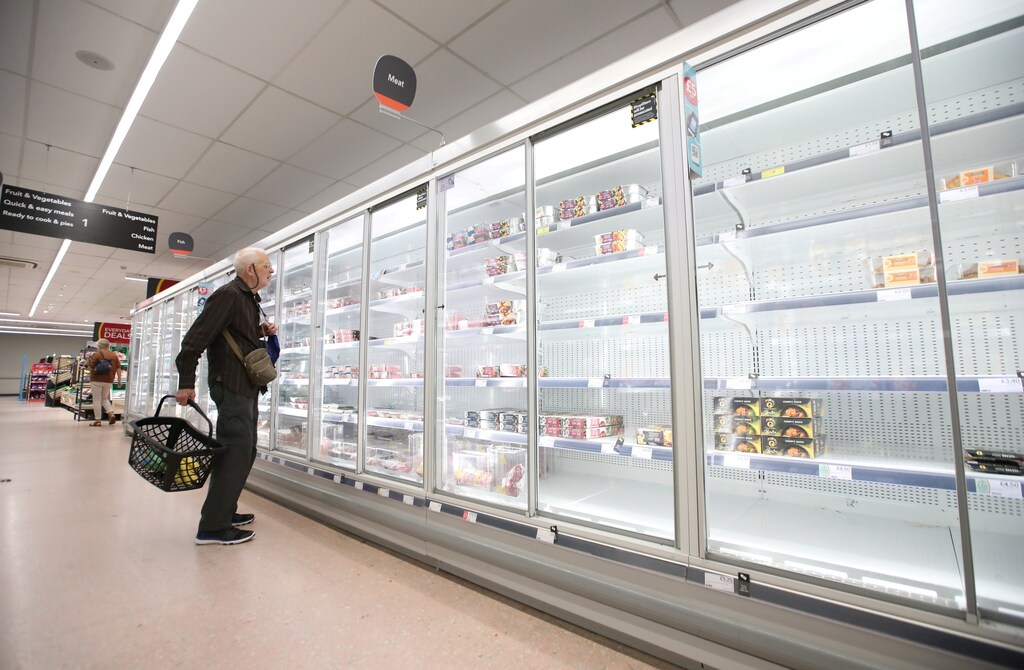 FILE PHOTO: A shopper looks at produce and empty shelves of the meat aisle in Co-Op supermarket, Harpenden, Britain, September 22, 2021. REUTERS/Peter Cziborra/File Photo