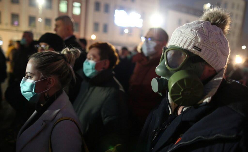 A demonstrator wears a gas mask during a protest over lacking measures to tackle heavy air pollution in Tuzla, Bosnia and Herzegovina environment energy change transition friendly environment carbon footprint carbon emissions reduction change natural climate change global warming air pollution clean energy power renewables