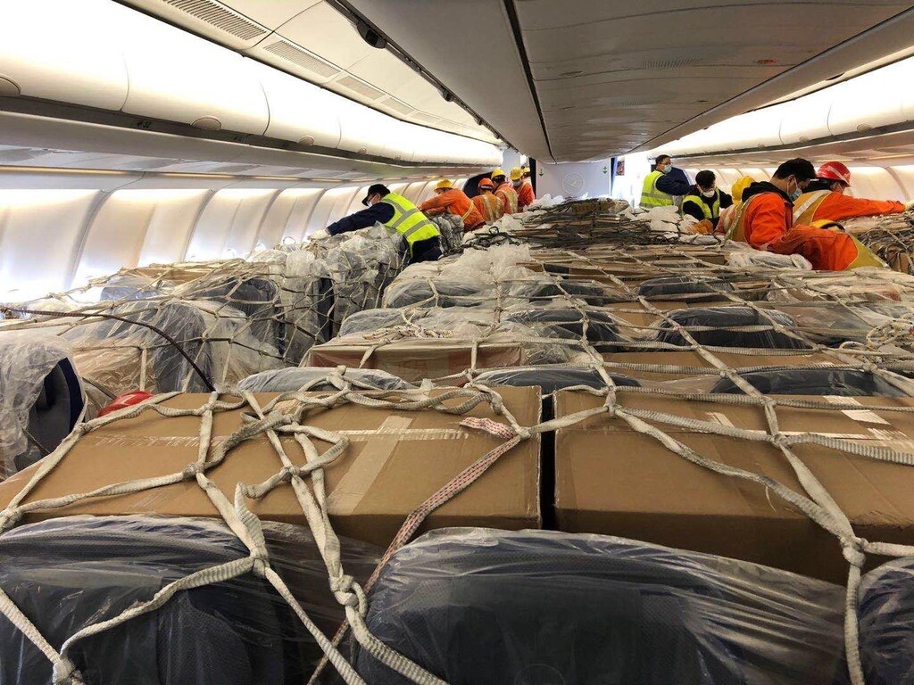 freight is tied into place in the passenger section of a passenger flight