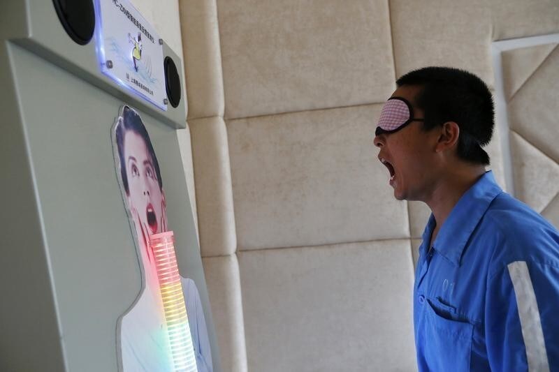A recovering drug addict shouts at a machine to unleash pent-up anger during a psychological therapy at the Shiliping compulsory drug rehabilitation centre in Longyou county, Zhejiang province June 19, 2014. Established in 2008, the centre is one of the biggest in China in terms of numbers of inmates and facilities. Recovering drug addicts in the centre are undergoing treatment with a strict regime in physical exercises, psychological therapies and medication, according to local media. Picture taken June 19, 2014.