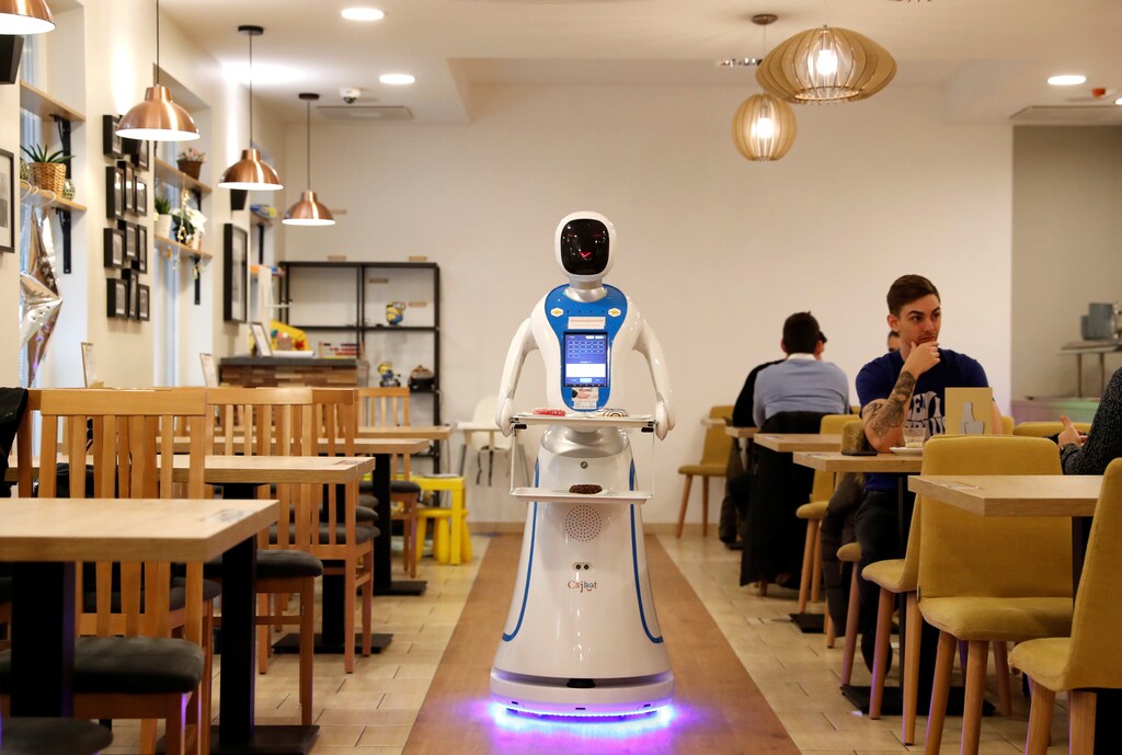 A robot waiter serves customers at a cafe in Budapest, Hungary, January 24, 2019. Picture taken January 24, 2019. REUTERS/Bernadett Szabo - RC141F8D1790