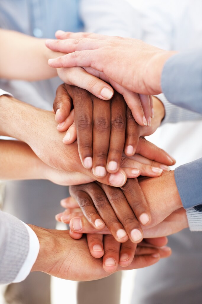 Hands placed on top of one another. Collaboration, mental health treatment
