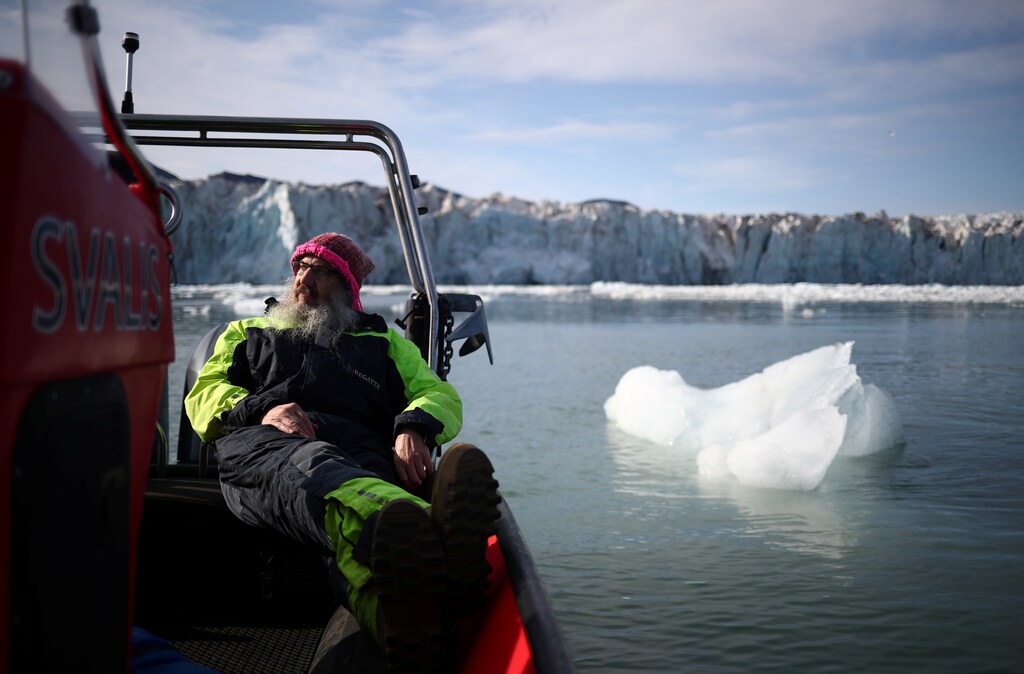 International director of the Norwegian Polar Institute, Kim Holmen, relaxes with a cup of tea as he travels past the Wahlenberg Glacier in Oscar II land at Spitsbergen in Svalbard, Norway, August 5, 2019. Holmen has lived in the northern Norwegian archipelago of Svalbard for three decades. He describes the changes he's seen as "profound, large and rapid." "We are losing the Svalbard we know. We are losing the Arctic as we know it because of climate change," he said. "This is a forewarning of all the hardship and problems that will spread around the planet." REUTERS/Hannah McKay SEARCH "SVALBARD CLIMATE" FOR THIS STORY. SEARCH "WIDER IMAGE" FOR ALL STORIES. - RC12AB368890