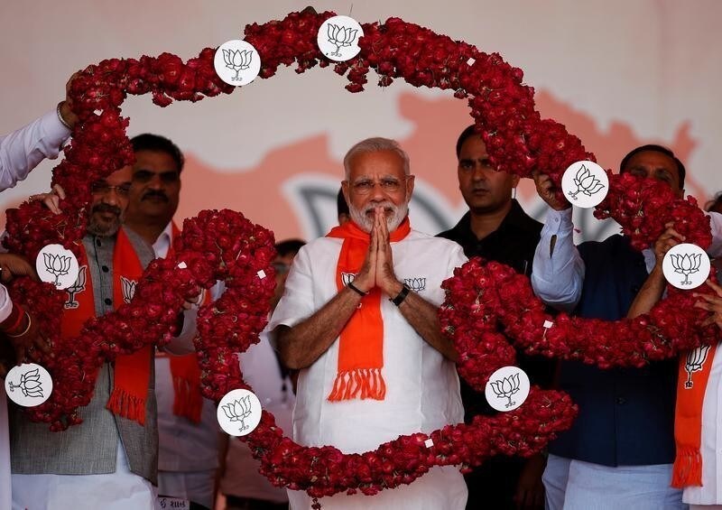 India's Prime Minister Narendra Modi is garlanded by supporters during a public rally at Bhaat village on the outskirts of Ahmedabad, India October 16, 2017. REUTERS/Amit Dave - RC174A92FC10