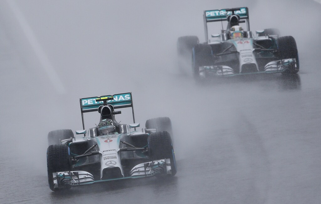 Mercedes Formula One driver Nico Rosberg of Germany leads teammate Lewis Hamilton of Britain behind a safety car (unseen) as they start the first lap of the rain-affected Japanese F1 Grand Prix at the Suzuka Circuit October 5, 2014. REUTERS/Toru Hanai (JAPAN - Tags: SPORT MOTORSPORT F1) - RTR48Z86