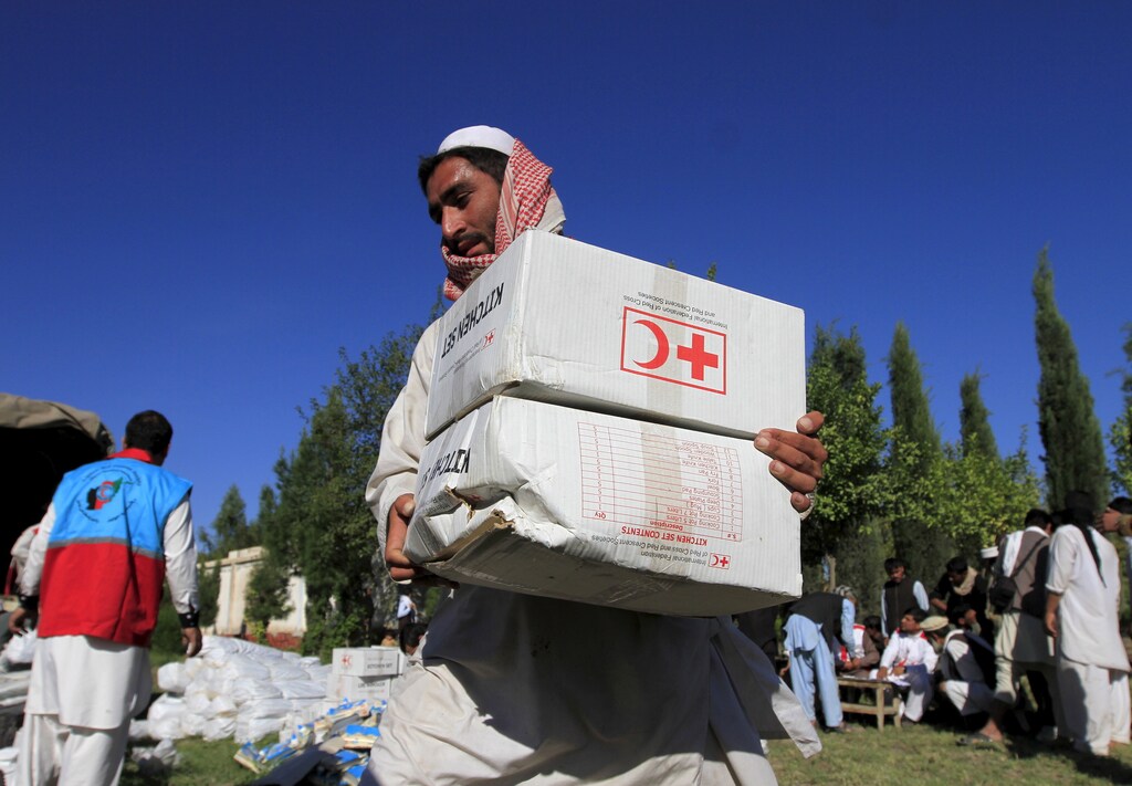 An Afghan man receives aid from the International Federation of the Red Cross and Red Crescent Societies after an earthquake, in Behsud district of Jalalabad province, Afghanistan October 28, 2015. The Taliban urged aid agencies on Tuesday to push ahead in delivering emergency relief supplies after a major earthquake hit remote mountainous regions of northern Afghanistan and Pakistan. Relief groups' efforts to assess the damage were hindered by an unstable security situation that has left much of the affected areas unsafe for international aid workers and government troops. But the Taliban, which have stepped up their Islamist insurgency against the Western-backed government in Kabul this year, indicated they would not stand in the way of aid efforts.