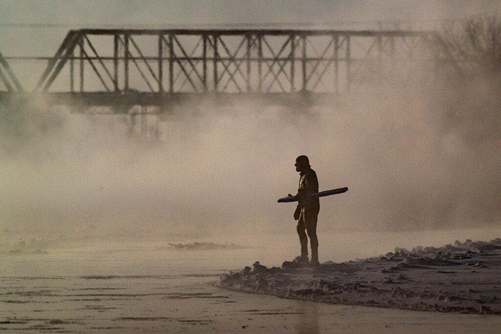 Man boogie boards in extreme cold in Montreal.