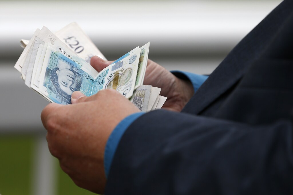 Britain Horse Racing - Grand National Festival - Aintree Racecourse - 6/4/17 General view as a bookmaker counts money during the Grand National Festival Action Images via Reuters / Andrew Boyers Livepic EDITORIAL USE ONLY. - RTX34CS6