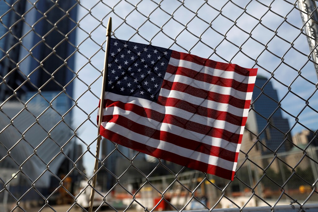 An American flag is seen left on a fence outside the National 9/11 Memorial and Museum during ceremonies marking the 16th anniversary of the September 11, 2001 attacks in New York, U.S., September 11, 2017. REUTERS/Shannon Stapleton - RC1E86015FC0
