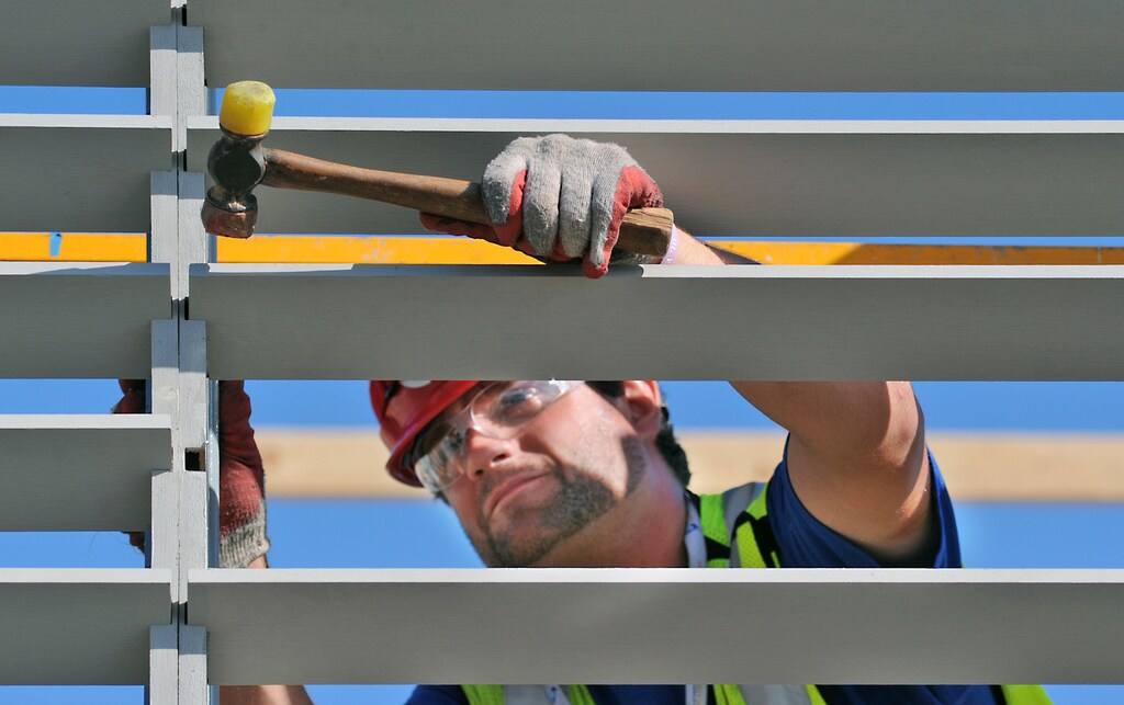Chris Hamm of Stevens Institute of Technology installs louvers on Day 5 of the U.S. Department of Energy Solar Decathlon at the Orange County Great Park, Irvine, California, in this handout picture taken October 2, 2015. Students from New Jersey-based Stevens Institute of Technology won the U.S. Department of Energy's Solar Decathlon, taking the top trophy at the event in California by building a flood-resistant house that is also energy efficient, officials said October 17, 2015. Picture taken October 2, 2015. REUTERS/ Thomas Kelsey/U.S. Department of Energy Solar Decathlon/Handout via Reuters THIS IMAGE HAS BEEN SUPPLIED BY A THIRD PARTY. IT IS DISTRIBUTED, EXACTLY AS RECEIVED BY REUTERS, AS A SERVICE TO CLIENTS. FOR EDITORIAL USE ONLY. NOT FOR SALE FOR MARKETING OR ADVERTISING CAMPAIGNS - TM3EBAH1AUK01