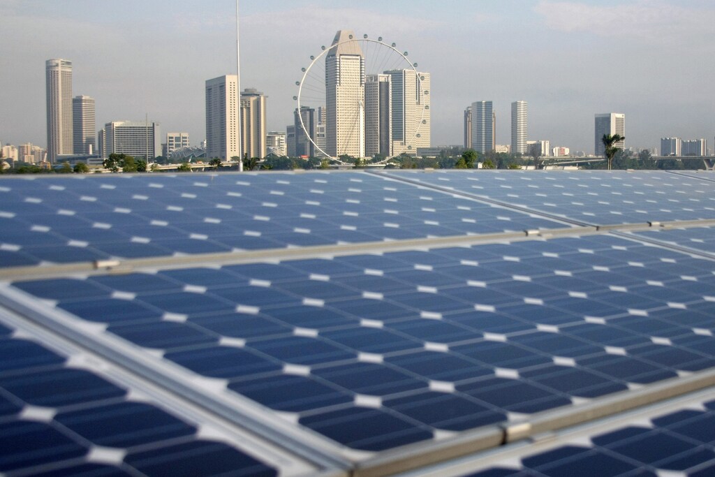 Solar panels are pictured on the Marina Barrage building, with the Singapore Flyer observation wheel and office and hotel buildings pictured in the background, in Singapore