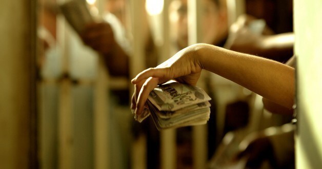A young Iraqi girl holds out her money as she queues for the early morning bread at the bread factory in Baghdad May 20 2003. Poorer Iraqis purchase the bread at a discount from the factory and then sell it by the roadsides on the black market.