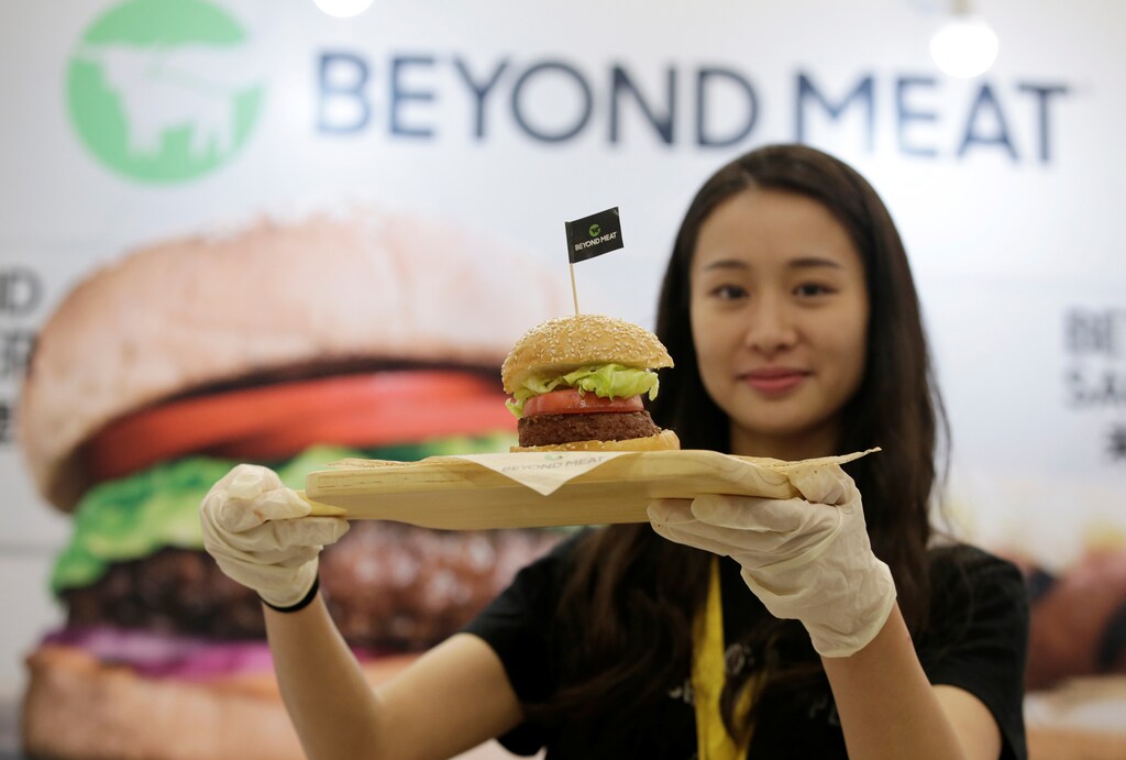 A staff member displays a burger with a Beyond Meat plant-based patty at VeggieWorld fair in Beijing, China November 8, 2019. Picture taken November 8, 2019. REUTERS/Jason Lee - RC2YDD9MVMC3