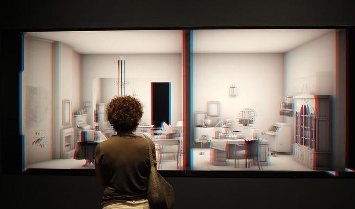 A visitor to the Jewish Museum in New York views one of Israeli artist and filmmaker Maya Zack's large-scale, computer-generated 3D prints July 29, 2011. "Living Room," an exhibit which explores how memory reconstructs reality, on view from July 31 to October 23, combines computer generated images of the apartment of Manfred Normburg, a German-born Jew, and his memories of everyday life in pre-war Berlin to study the intersection of personal memory with historical events. REUTERS/Mike Segar (UNITED STATES - Tags: ENTERTAINMENT)