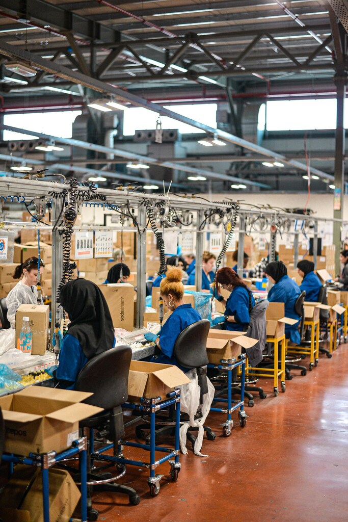 This image shows women working on a factory line to illustrate the need to reduce gender inequality in the workplace