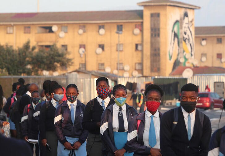 Students queue before being screened as schools begin to reopen after the coronavirus disease (COVID-19) lockdown in Langa township in Cape Town, South Africa June 8, 2020. REUTERS/Mike Hutchings