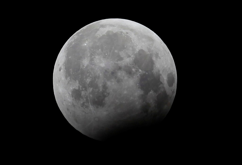 The moon is seen during a partial lunar eclipse is seen in the sky in Rawalpindi, Pakistan August 8, 2017. REUTERS/Faisal Mahmood - RC16D1332D80