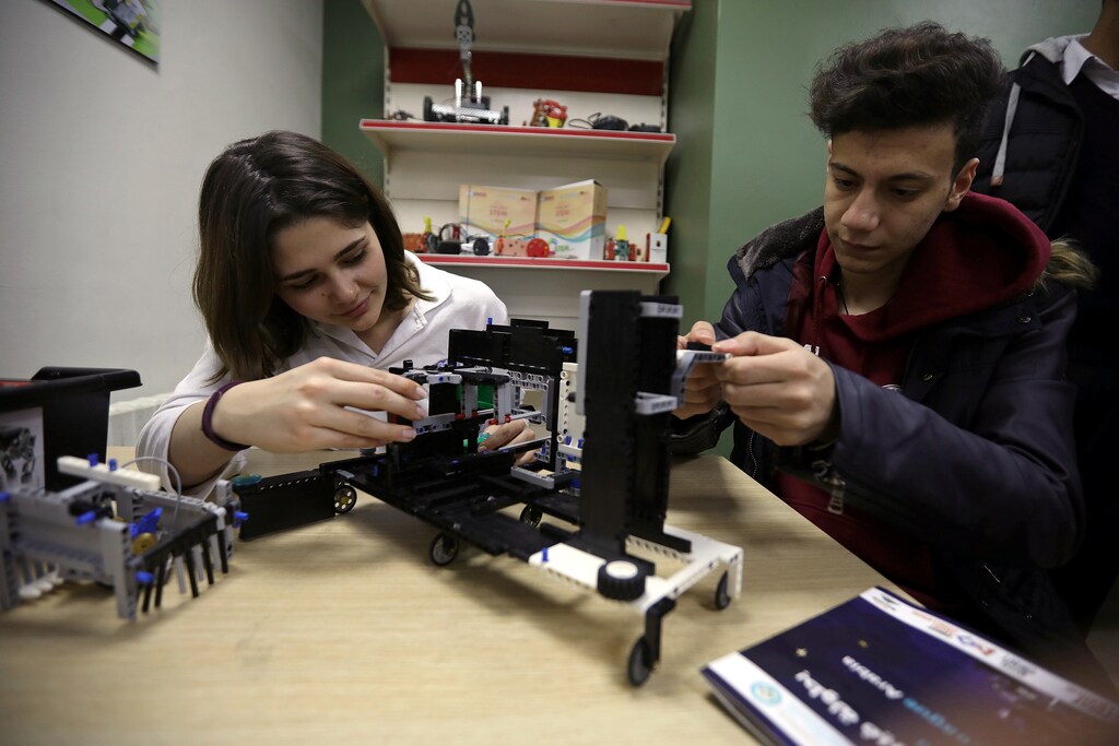Students work on programming and developing their robots to work in a virtual space station at Jubilee School in Amman, Jordan, February 10, 2019. REUTERS/Muhammad Hamed - RC166910D210