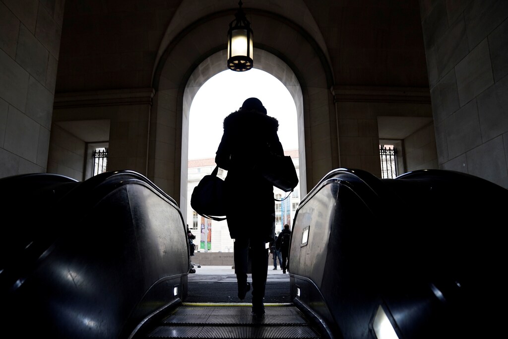 Commuters walk from the Federal Triangle Metro station after the U.S. government reopened with about 800,000 federal workers returning after a 35-day shutdown in Washington, U.S., January 28, 2019. REUTERS/Joshua Roberts - RC18AFA488A0