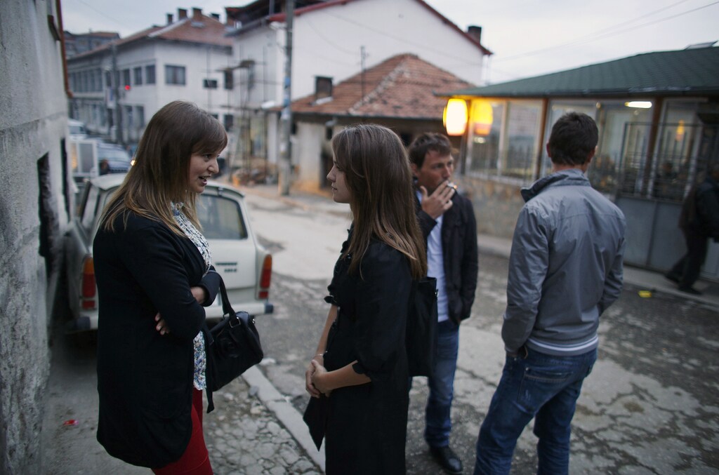 Bulgarian Nevse Molalieva (L) chats with friends on a street in the village of Ribnovo, some 190km (118 miles) south of Sofia May 8, 2013. Eurostat shows that Bulgaria's youth unemployment rate is among the highest in the European Union but German businessman Bertram Rollman has found a way to give the young women in the small southern Bulgarian village of Ribnovo better job prospects -- a dual education system popular in his native Germany. Rollman owns a sewing factory which provides training for some 40 young people, including Molalieva, equipping them with skills for an edge during job hunts. Fighting unemployment and poverty are priorities for almost every political party running for the next parliament in the country's elections on May 12, after mass protests against widespread corruption and low-living standards toppled the ruling centre-right government in February. Picture taken May 8, 2013. REUTERS/Stoyan Nenov (BULGARIA - Tags: BUSINESS POLITICS EDUCATION ELECTIONS EMPLOYMENT SOCIETY) - GM1E9591LAH01