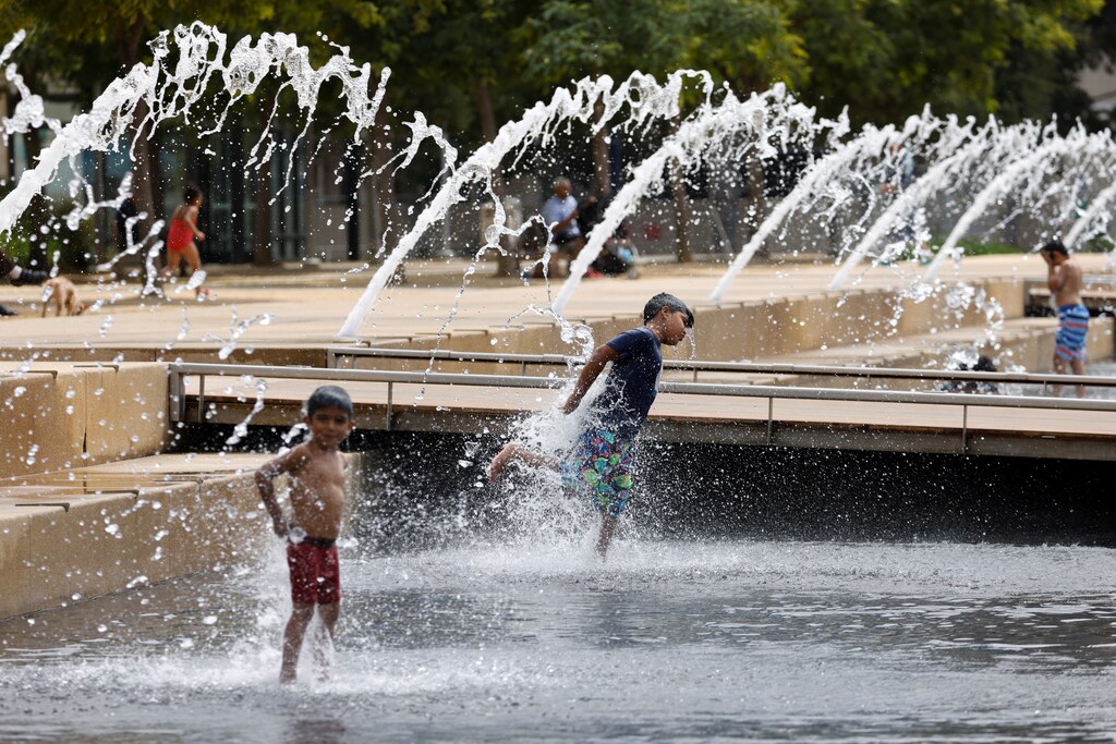 Children cool off in a city fountain amid a heatwave during the outbreak of the coronavirus disease (COVID-19) in San Diego, California, U.S., AUGUST 18, 2020. REUTERS/Mike Blake - RC2LGI9OJ0HB