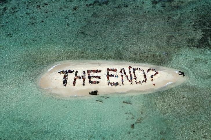 Hundreds of Belizians and international supporters gather on an island to form a message on the Barrier Reef off the coast of Belize City November 13, 2010. The message, which was to call on humanity to be in harmony with the natural world, was created on the final day of the three-day Belize Reef Summit and is part of the launch of the Harmony Initiative, a partnership between the film "Harmony" narrated by Britain's Prince Charles and the Global Campaign for Climate Action. REUTERS/Lou Dematteis/Spectral Q/Handout (BELIZE - Tags: SOCIETY ENVIRONMENT) FOR EDITORIAL USE ONLY. NOT FOR SALE FOR MARKETING OR ADVERTISING CAMPAIGNS. THIS IMAGE HAS BEEN SUPPLIED BY A THIRD PARTY. IT IS DISTRIBUTED, EXACTLY AS RECEIVED BY REUTERS, AS A SERVICE TO CLIENTS BEST QUALITY AVAILABLE