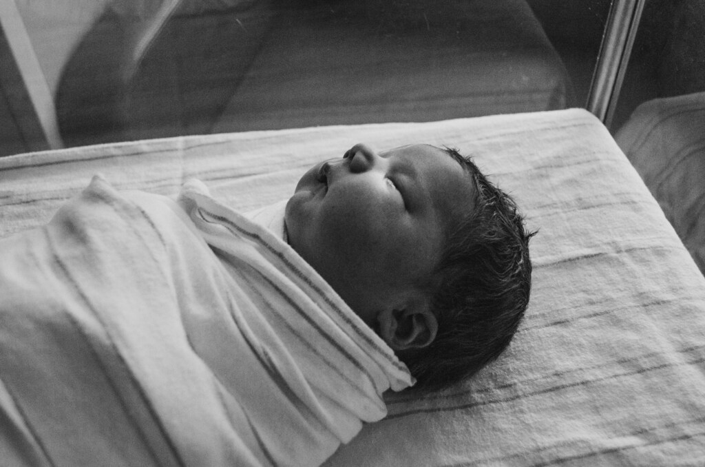 This image shows a swaddled baby, illustrating that adoption rates in India are low, despite the high number of abandoned and orphaned children