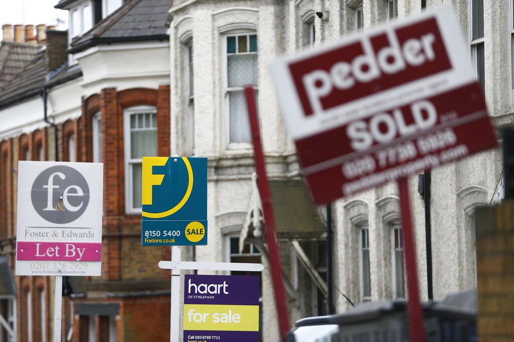 Estate agents boards are lined up outside houses in south London June 3, 2014. Britain's house prices rose at their fastest annual pace in nearly seven years last month and signs of bottlenecks in the construction sector underscored the upward pressures on the market, surveys showed on Tuesday. House price growth picked up to an annual pace of 11.1 percent in May, mortgage lender Nationwide said, fanning concerns that the property market could be overheating. REUTERS/Andrew Winning (BRITAIN - Tags: POLITICS BUSINESS REAL ESTATE) - LM1EA6317J601