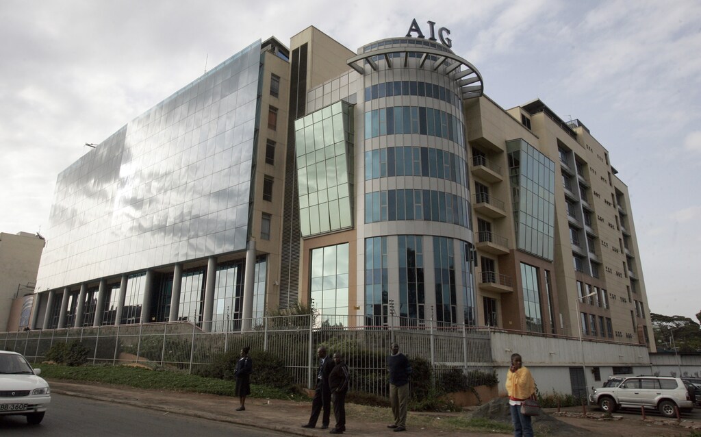 People walk in front of the AIG building, which hosts the Finnish and Swedish embassies, in Nairobi June 23, 2008. The Finnish and Swedish embassies in Kenya were evacuated on Monday after a bomb threat, but police said no device was found, Finland's ambassador Heli Sirve said.