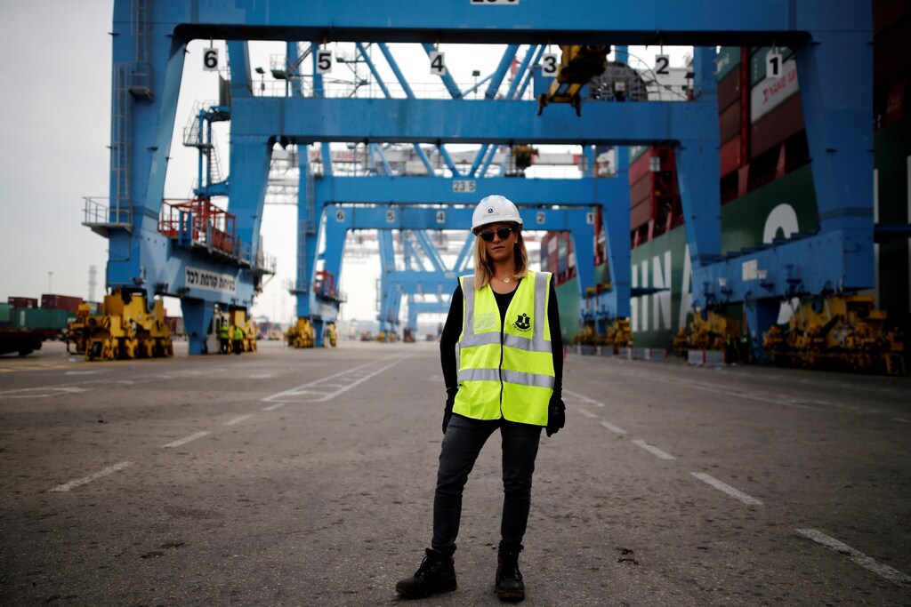 Liz Azoulay, 26, who loads and unloads cargo at Ashdod port, poses for a photograph at the port, in Ashdod, southern Israel, February 22, 2017. "In most of my professional life I did not face any inequality. In the port of Ashdod we are equal on the docks. I am the first woman who began working at the Ashdod port as a stevedore." REUTERS/Amir Cohen SEARCH "WOMEN WORK" FOR THIS STORY. SEARCH "WIDER IMAGE" FOR ALL STORIES. - RC19E4D97240