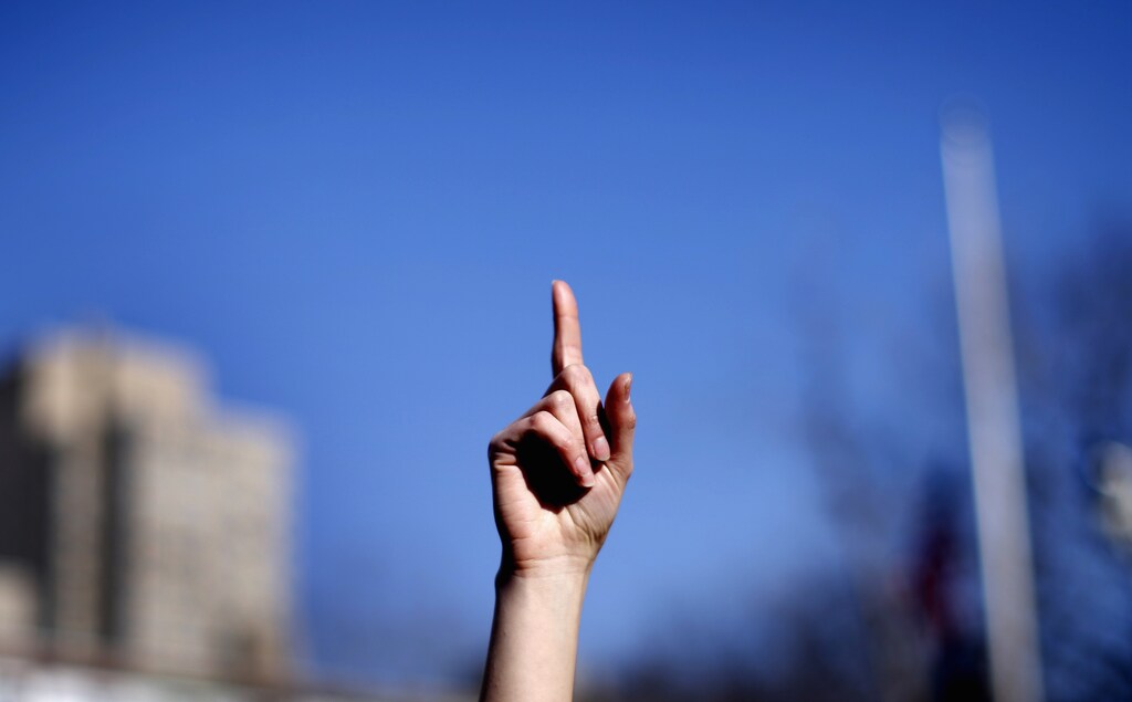 A woman raises a finger to the air as she dances with others to the theme song of the "One Billion Rising" campaign in New York City's Washington Square Park on Valentines Day February 14, 2013. "One Billion Rising" is a campaign aimed to call an end to violence against women and girls. This date marks the 15th Anniversary of when V-Day was founded by award-winning playwright Eve Ensler and the One Billion Rising campaign is based on the statistic that 1 in 3 women will be beaten or raped in her lifetime according to organizers. REUTERS/Mike Segar (UNITED STATES - Tags: SOCIETY CIVIL UNREST) - GM1E92F0DNR01