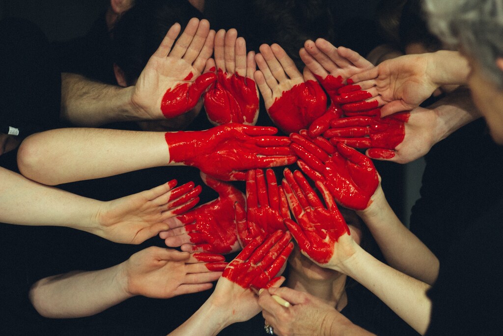 Hands painted red to form a heart shape