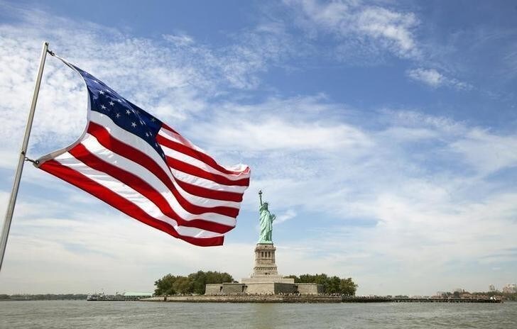 An U.S. flag waves in the wind on a boat near the Statue of Liberty in New York August 31, 2011. REUTERS/Lucas Jackson (UNITED STATES - Tags: CITYSPACE)