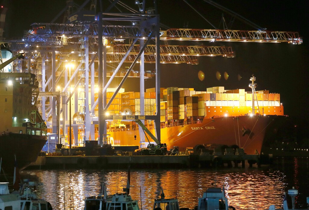 A container ship is pictured next to cranes in Valparaiso port, Chile, March 21, 2017.