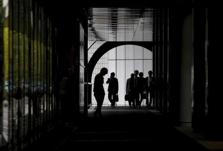 Businessmen walk at an office building in Tokyo June 18, 2015. REUTERS/Toru Hanai