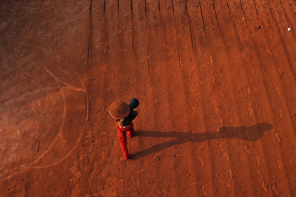 Mithun, 11, carries a container full of dust on his shoulder at a laterite brick mine in Ratnagiri District, about 360km (224 miles) south of Mumbai, April 14, 2011. He is paid two Indian rupees ($0.04) per brick and carries an average of 100 bricks out of the mine each day. Each brick costs between 10-14 rupees ($0.22-$0.31), and weighs around 40kg. REUTERS/Danish Siddiqui - RTS1BPZN