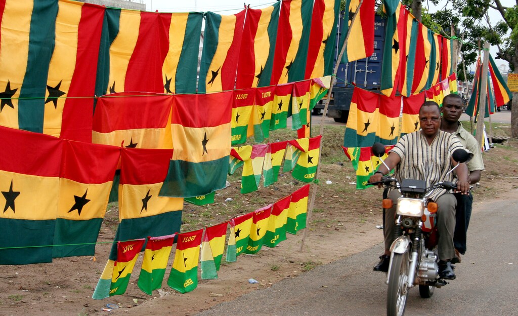 A Ghanaian motorcyclist rides past flags and soccer jerseys adorning the streets of the capital, Accra, June 4, 2006. REUTERS\Yaw Bibini