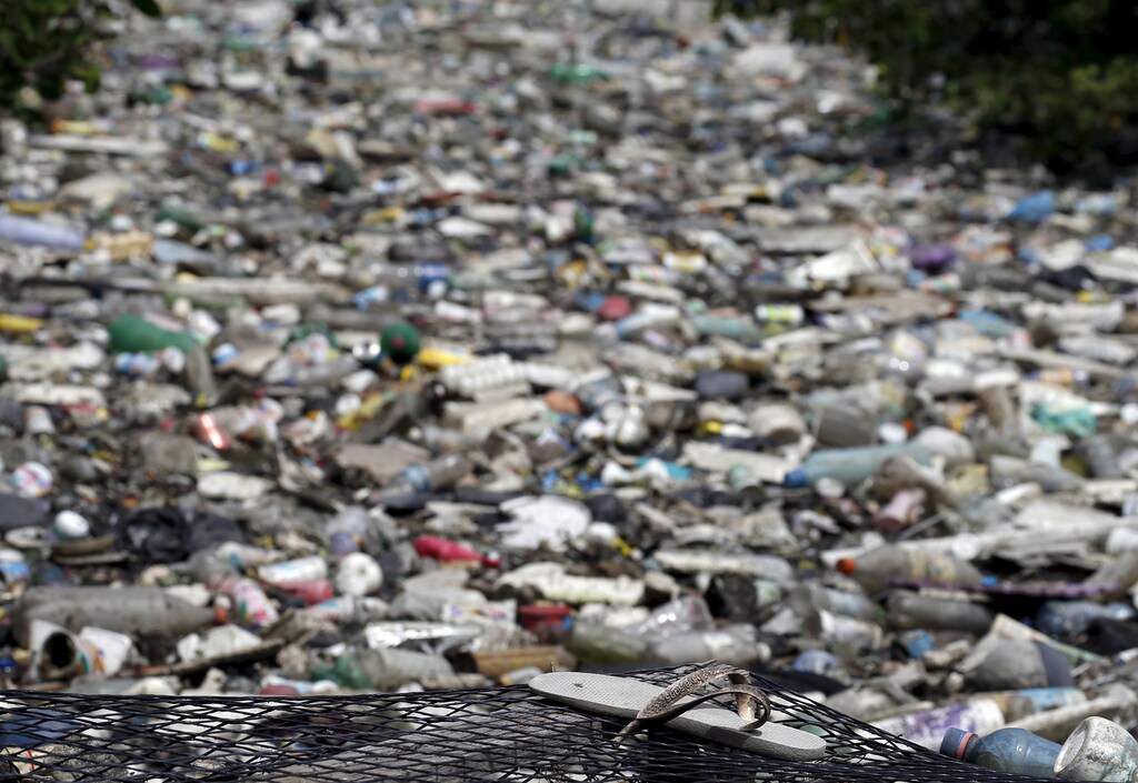 Rubbish covers the banks of Cunha channel, which flows into Guanabara Bay, in Rio de Janeiro March 31, 2015. As part of its Olympic bid, Rio promised to clean up 80 percent of the bay for the games, where will be host the sailing event. But local government officials have already admitted that a cleanup by 2016 is not achievable. REUTERS/Sergio Moraes - GF10000045257