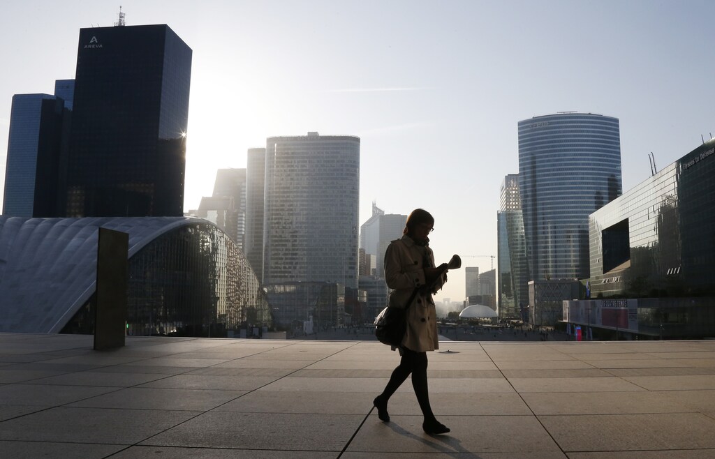 A woman walks on the esplanade of La Defense, in the financial and business district in La Defense, west of Paris, April 10, 2014. REUTERS/Gonzalo Fuentes (FRANCE - Tags: BUSINESS) - RTR3KUF7